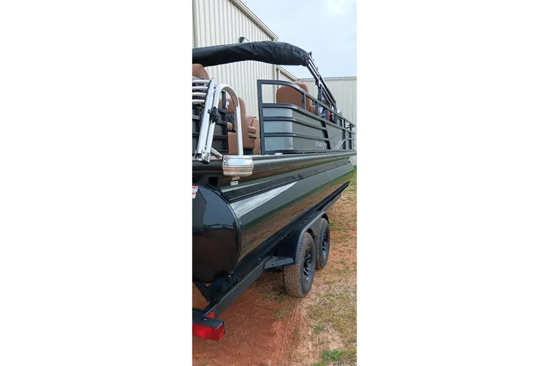 Slide: The Image of 2026 Ranger 220F boat on trailer, parked near a building. - 5