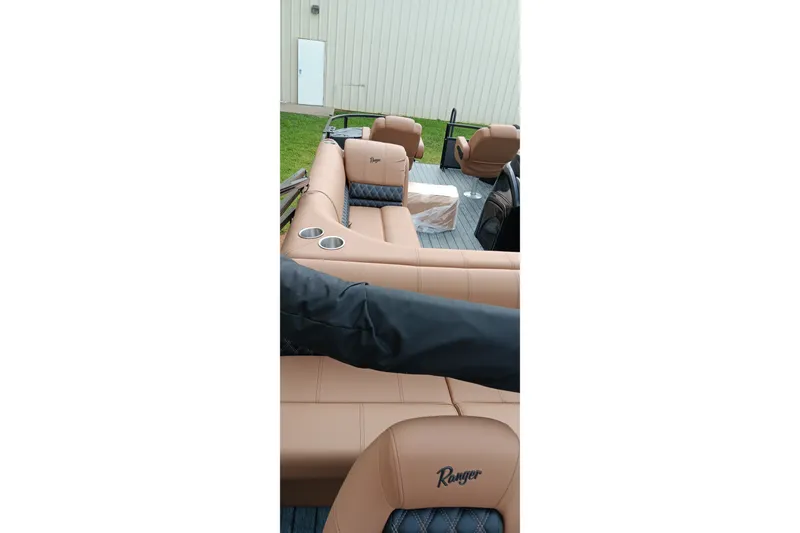 Slide: The Image of 2026 Ranger 220F boat interior with tan seating and cup holders. - 12