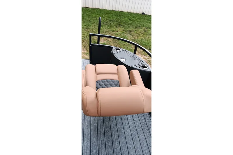 Slide: The Image of Luxurious seating on 2026 Ranger 220F boat with tan upholstery and cup holders. - 19