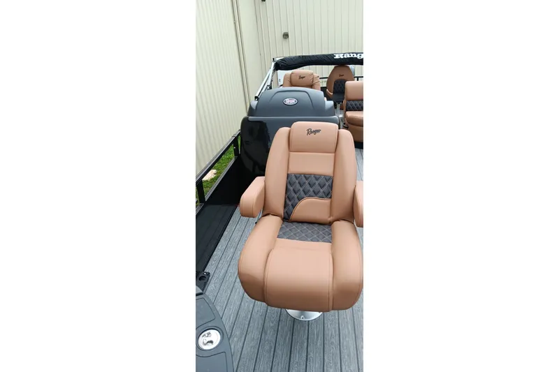 Slide: The Image of Luxurious seating on 2026 Ranger 220F boat, featuring tan and gray upholstery. - 25