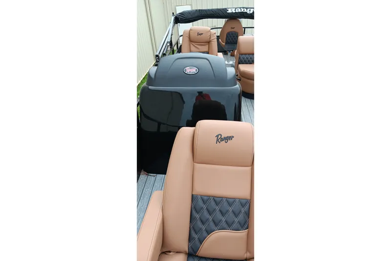 Slide: The Image of 2026 Ranger 220F boat interior with tan and black seating, featuring Ranger logo. - 28