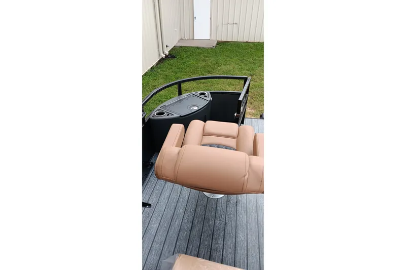 Slide: The Image of 2026 Ranger 220F boat interior with tan seating and control panel. - 18