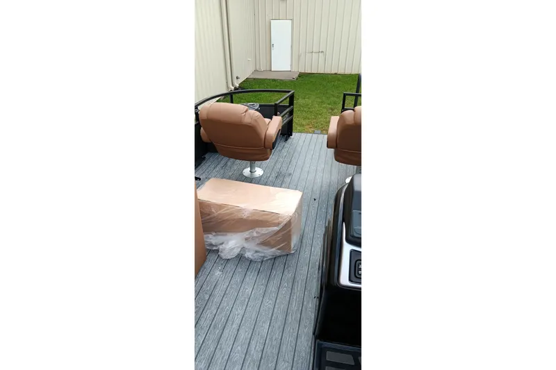 Slide: The Image of 2026 Ranger 220F boat interior with brown seats and packaged item on deck. - 15