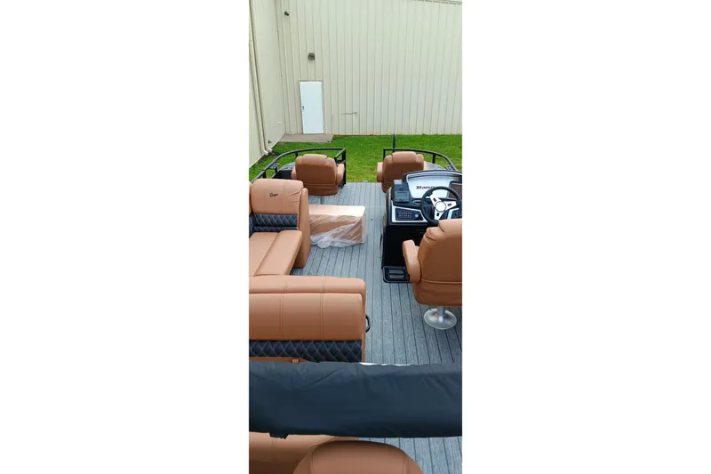Slide: The Image of 2026 Ranger 220F boat interior with tan seating and modern dashboard. - 11