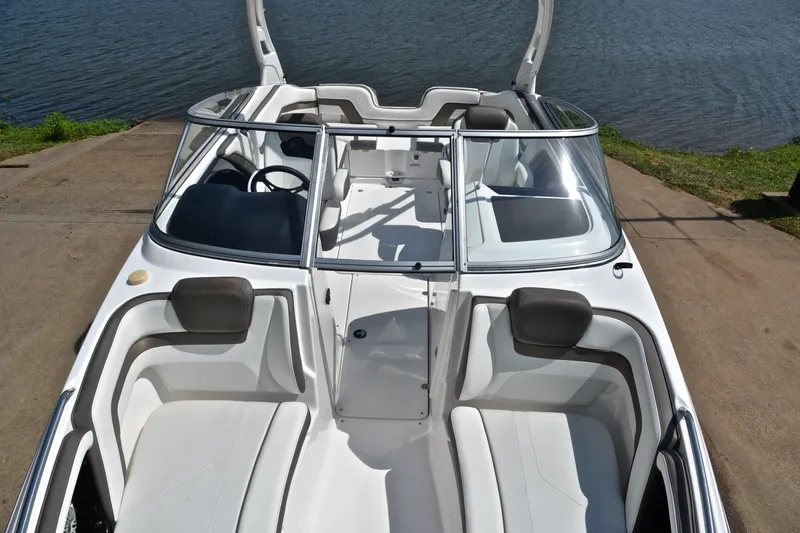 Slide: The Image of 2015 Yamaha Boats 242 Limited S, white interior, docked by the water. - 19