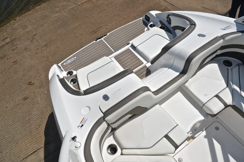 Slide: The Image of 2015 Yamaha Boats 242 Limited S interior with white seating and cup holders. - 22