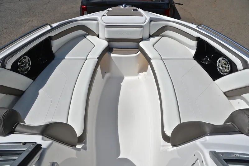 Slide: The Image of 2015 Yamaha Boats 242 Limited S interior with white seating and speakers. - 20
