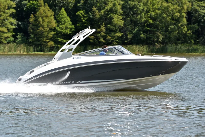 Slide: The Image of 2015 Yamaha Boats 242 Limited S cruising on a lake with lush green trees. - 3