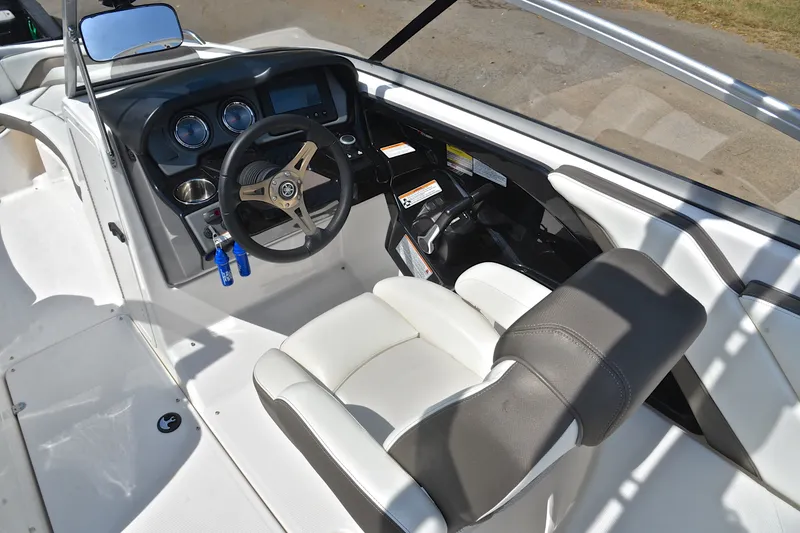 Slide: The Image of 2015 Yamaha Boats 242 Limited S cockpit with steering wheel and dashboard controls. - 24