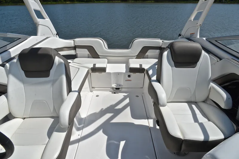 Slide: The Image of Interior of 2015 Yamaha Boats 242 Limited S, featuring sleek white seating and modern design. - 21
