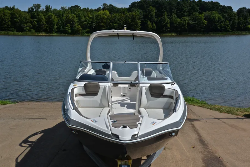 Slide: The Image of 2015 Yamaha Boats 242 Limited S on a boat ramp by a serene lake. - 16