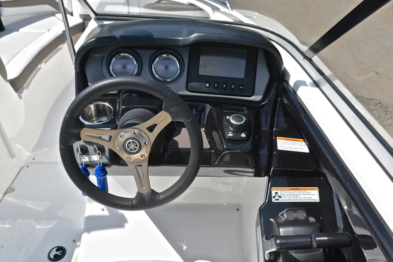 Slide: The Image of 2015 Yamaha Boats 242 Limited S dashboard with steering wheel and controls. - 25