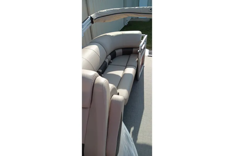 Slide: The Image of 2025 Sun Tracker Party Barge 24 DLX interior with beige seating and canopy. - 23