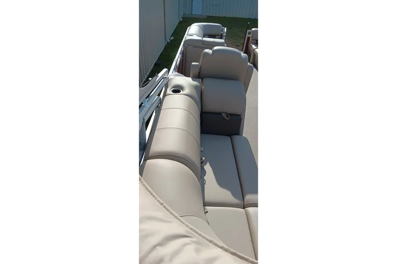 Slide: The Image of 2025 Sun Tracker Party Barge 24 DLX with beige seating and cup holders. - 6