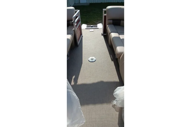 Slide: The Image of Interior view of 2025 Sun Tracker Party Barge 24 DLX with beige seating and flooring. - 25