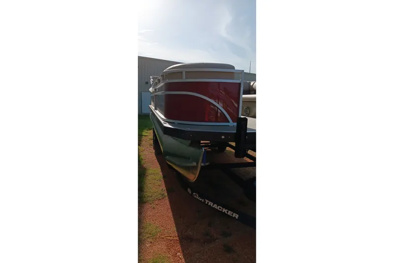 Slide: The Image of 2025 Sun Tracker Party Barge 24 DLX pontoon boat on trailer, side view. - 20