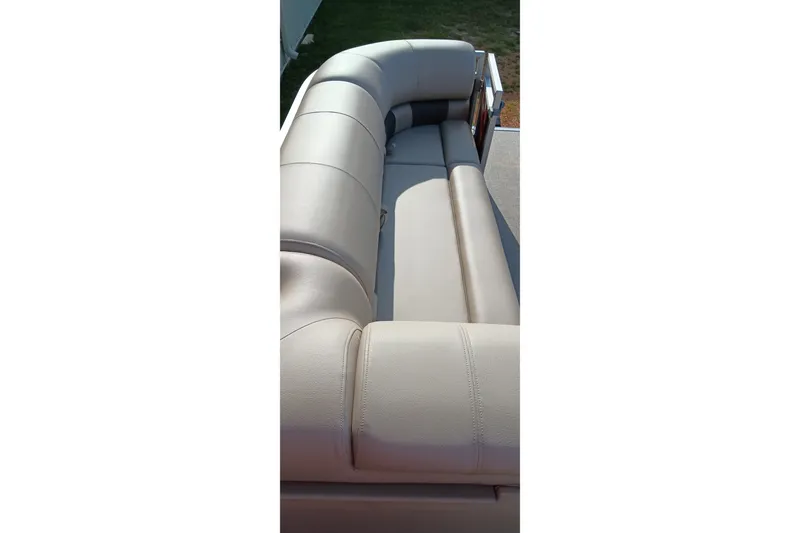 Slide: The Image of 2025 Sun Tracker Party Barge 24 DLX, featuring luxurious beige seating. - 11