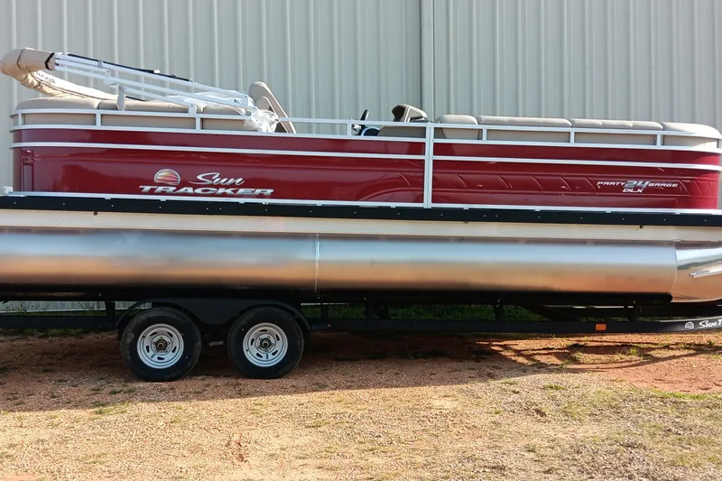 The Image of 2025 Sun Tracker Party Barge 24 DLX pontoon boat on trailer, side view. - 0