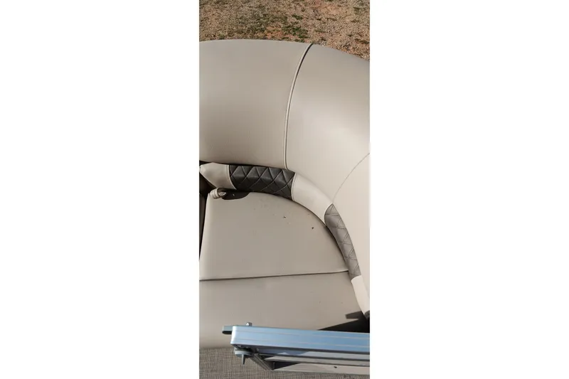Slide: The Image of 2025 Sun Tracker Party Barge 24 DLX seating with beige upholstery and diamond-pattern accents. - 8