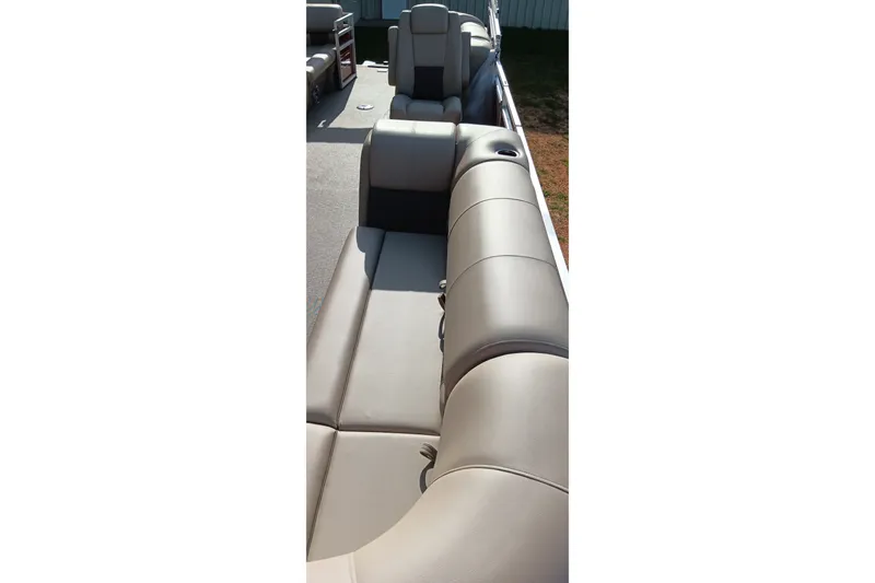 Slide: The Image of 2025 Sun Tracker Party Barge 24 DLX interior with plush seating and cup holders. - 22