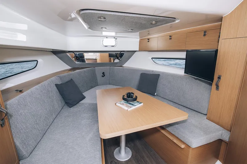 Slide: The Image of Manufacturer Provided Image: Interior of 2026 Beneteau Flyer 10, featuring a cozy seating area with a table. - 5