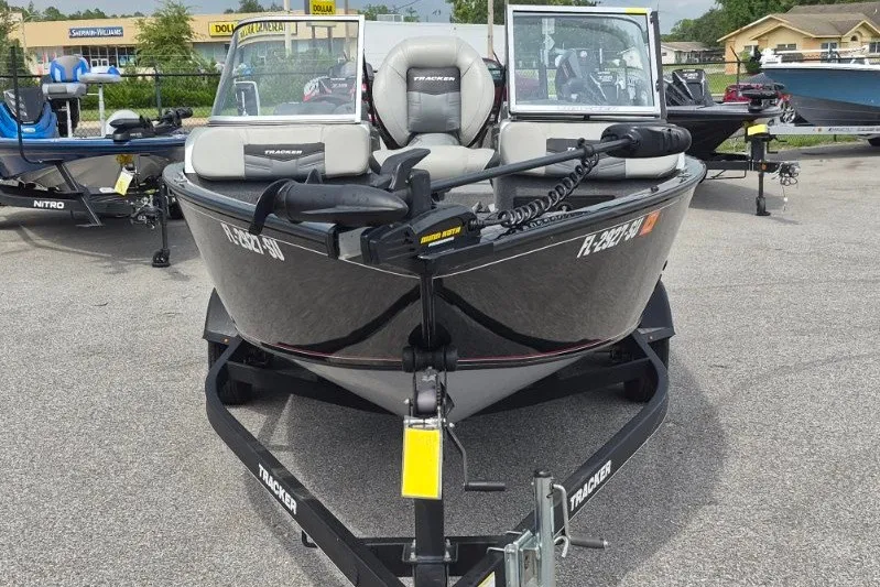 Slide: The Image of 2018 Tracker Pro Guide V-175 Combo boat on trailer in outdoor dealership lot. - 2