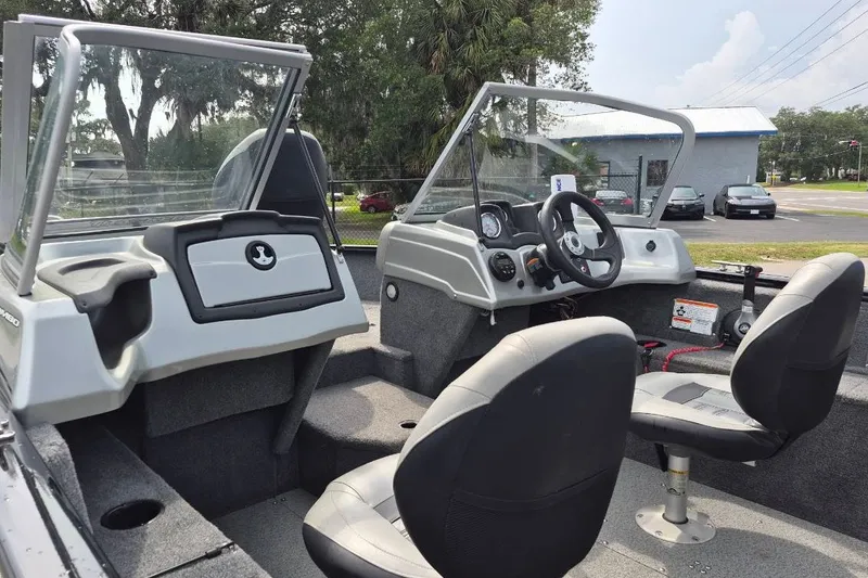 Slide: The Image of 2018 Tracker Pro Guide V-175 Combo boat interior with dual seats and steering console. - 13