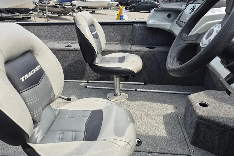 Slide: The Image of 2018 Tracker Pro Guide V-175 Combo boat interior with two seats and steering wheel. - 9