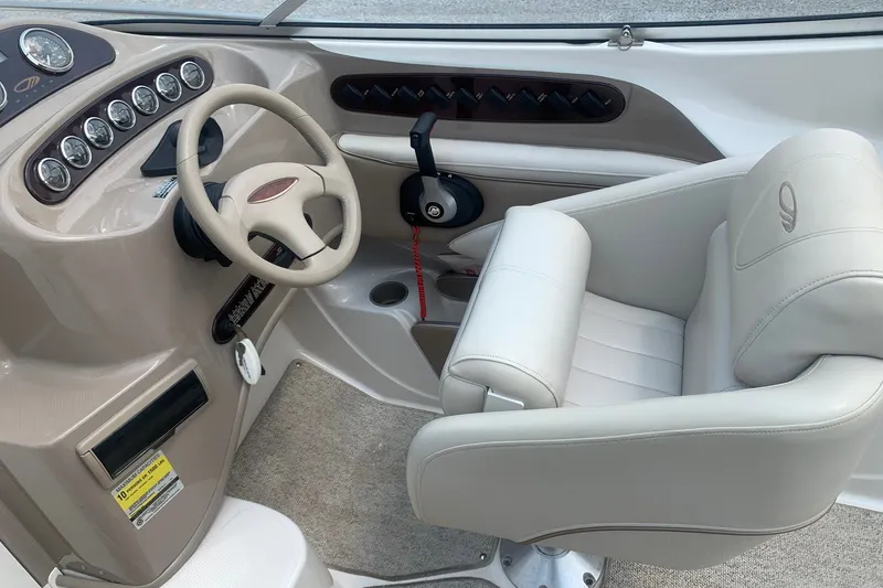 Slide: The Image of Interior of a 2000 Maxum 2300 SC boat, featuring steering wheel and captain's chair. - 6