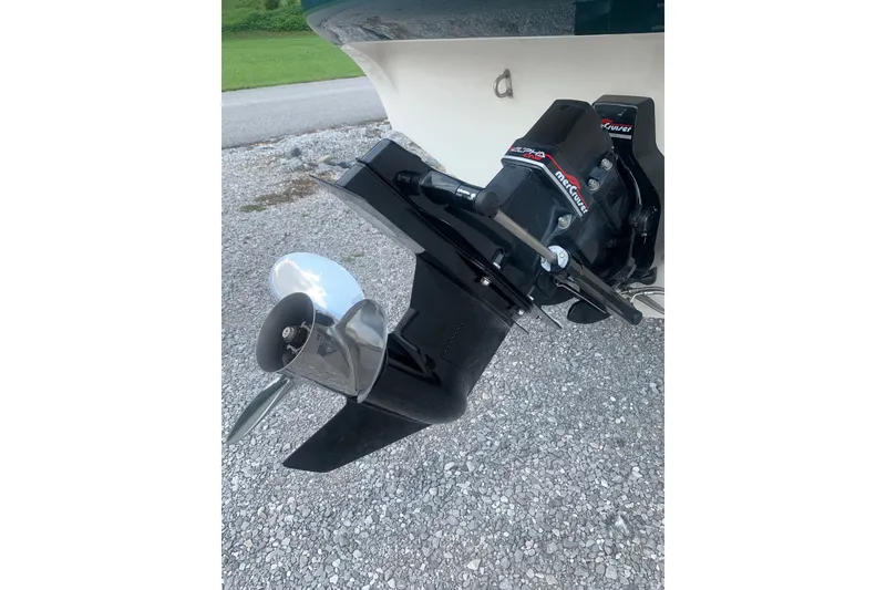 Slide: The Image of Outboard motor of 2000 Maxum 2300 SC boat on gravel surface. - 22
