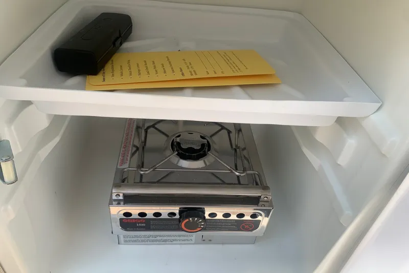 Slide: The Image of Boat interior with a portable stove and storage shelf, Maxum 2300 SC, 2000 model. - 20