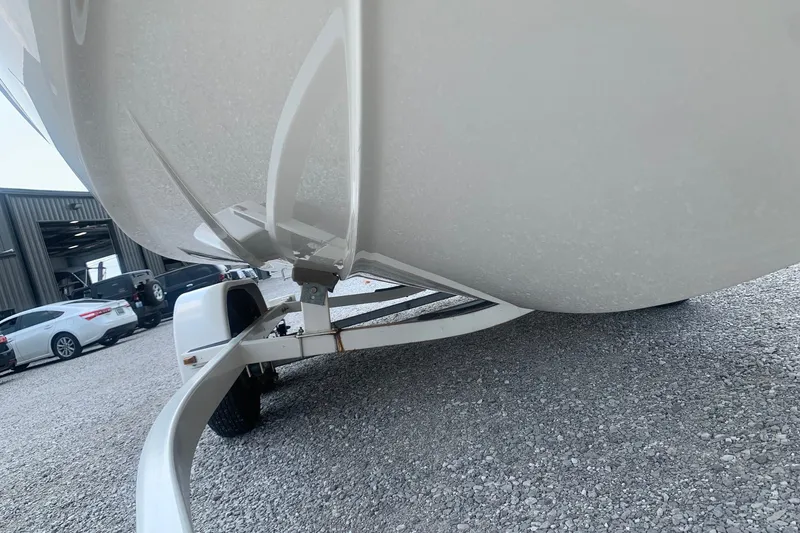Slide: The Image of Trailer supporting a 2000 Maxum 2300 SC boat on gravel surface. - 5