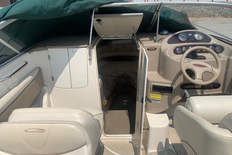 Slide: The Image of 2000 Maxum 2300 SC boat interior with steering wheel and cabin entrance. - 7