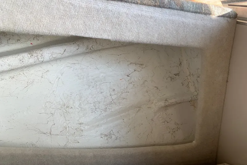 Slide: The Image of Interior detail of a 2000 Maxum 2300 SC boat showing worn upholstery. - 25