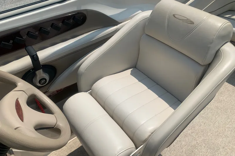 Slide: The Image of Captain's seat and steering wheel of a 2000 Maxum 2300 SC boat. - 12