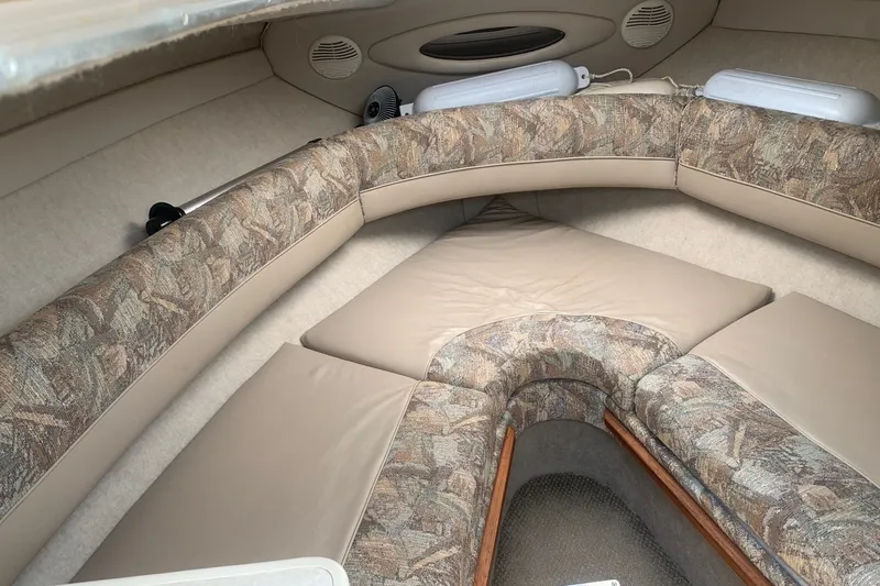 Slide: The Image of Interior of a 2000 Maxum 2300 SC boat with cushioned seating. - 16