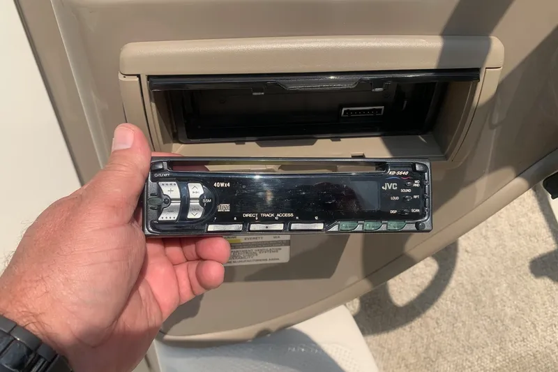 Slide: The Image of Hand holding JVC car stereo faceplate, Maxum 2300 SC boat dashboard, 2000 model. - 9