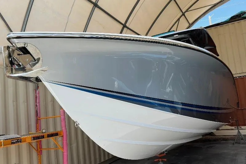 Slide: The Image of 2024 Nor-Tech 340 Sport boat in storage, showcasing sleek hull design. - 3