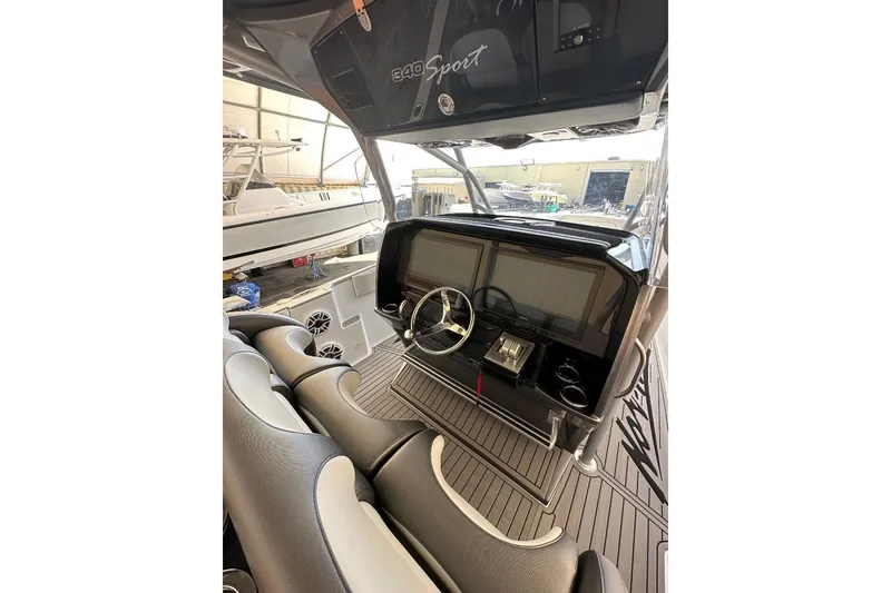 The Image of 2024 Nor-Tech 340 Sport boat interior with modern dashboard and steering wheel. - 1