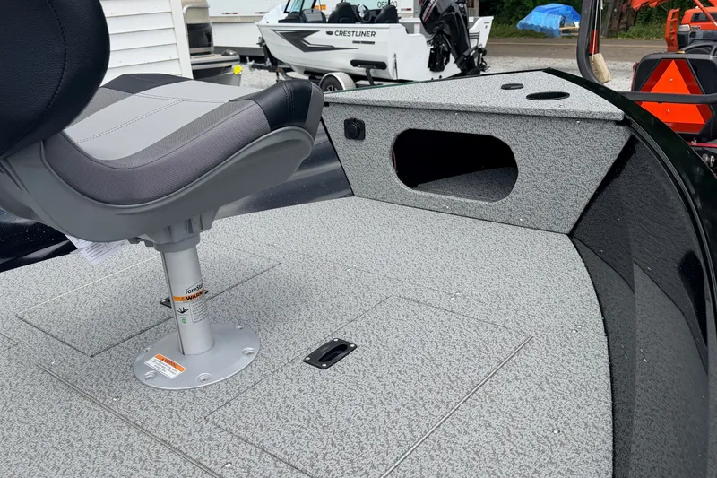 Slide: The Image of 2027 Crestliner 1650 Kodiak SC boat interior with gray seating and storage compartments. - 6