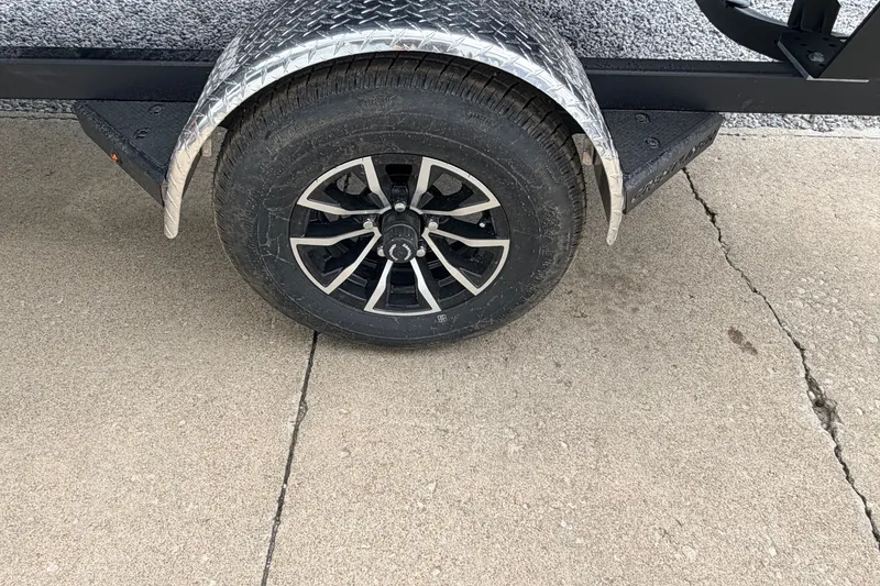 Slide: The Image of Trailer wheel of 2027 Crestliner 1650 Kodiak SC on concrete surface. - 8
