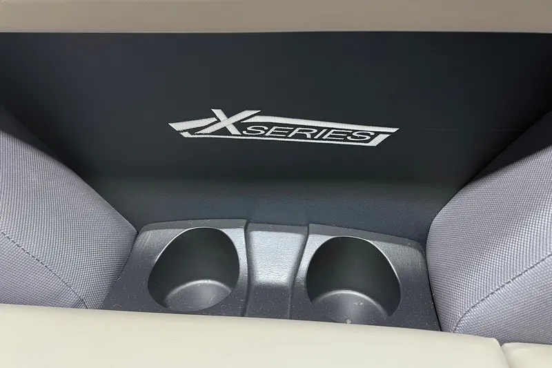 Slide: The Image of Interior of 2026 Sylvan X3 featuring cup holders and X Series branding. - 19