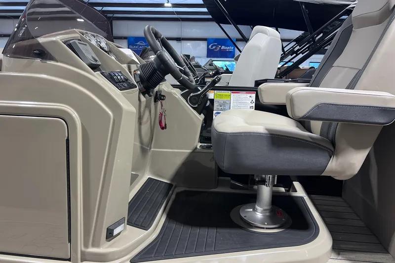 Slide: The Image of Interior of 2026 Sylvan X3 boat showing steering console and captain's chair. - 24