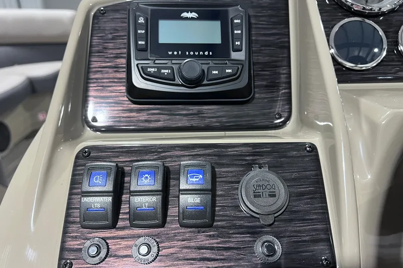 Slide: The Image of Control panel of 2026 Sylvan X3 boat with switches and audio system. - 26