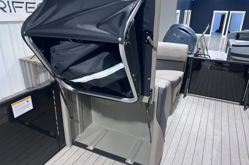 Slide: The Image of 2026 Sylvan X3 boat interior with storage compartment and seating area. - 22