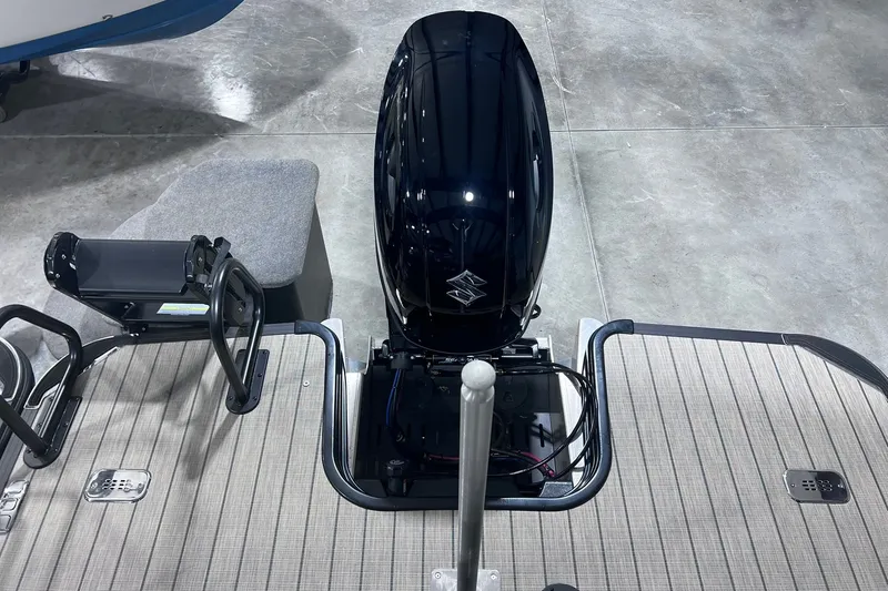 Slide: The Image of 2026 Sylvan X3 boat with sleek outboard motor on display in showroom. - 14