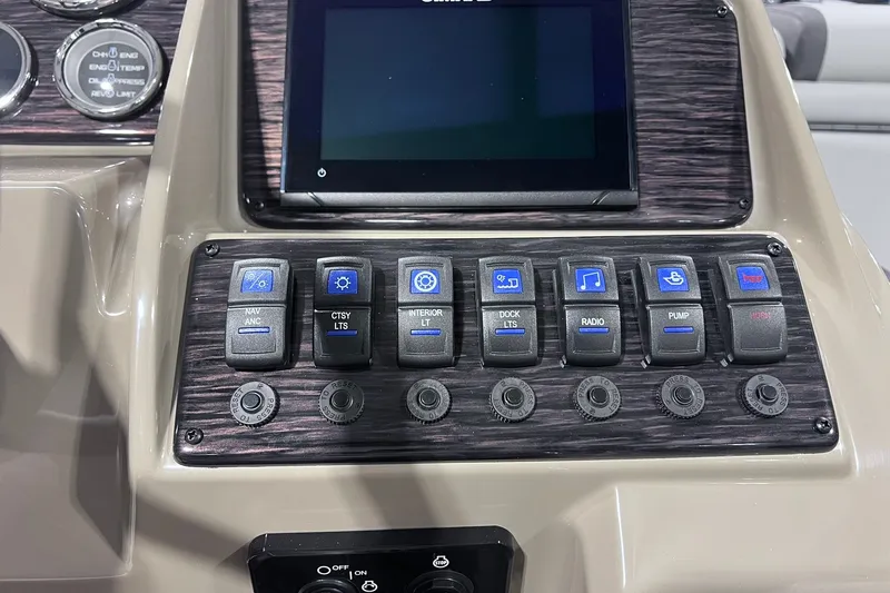 Slide: The Image of Control panel of 2026 Sylvan X3 boat with various switches and display screen. - 25