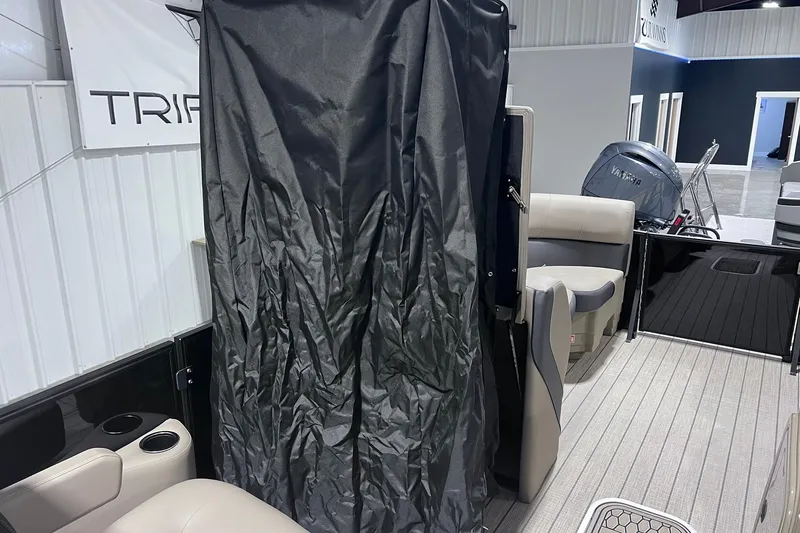 Slide: The Image of 2026 Sylvan X3 boat interior with seating, curtain, and Yamaha engine. - 23