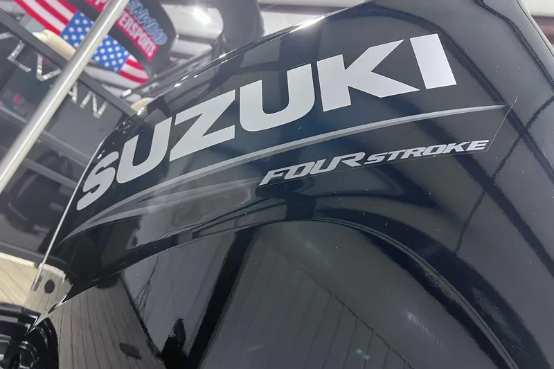 Slide: The Image of Suzuki Four Stroke engine on 2026 Sylvan X3 boat, American flag in background. - 31