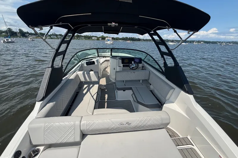Slide: The Image of 2025 Sea Ray SDX 250 Outboard boat interior with spacious seating on a calm lake. - 3